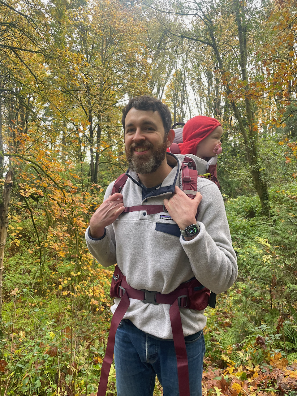 Leon and his daughter on a trail surrounded by autumn woodland